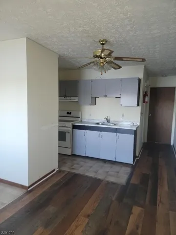 a kitchen with stainless steel appliances a sink a stove and cabinets