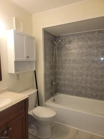 a bathroom with a toilet a sink and bathtub