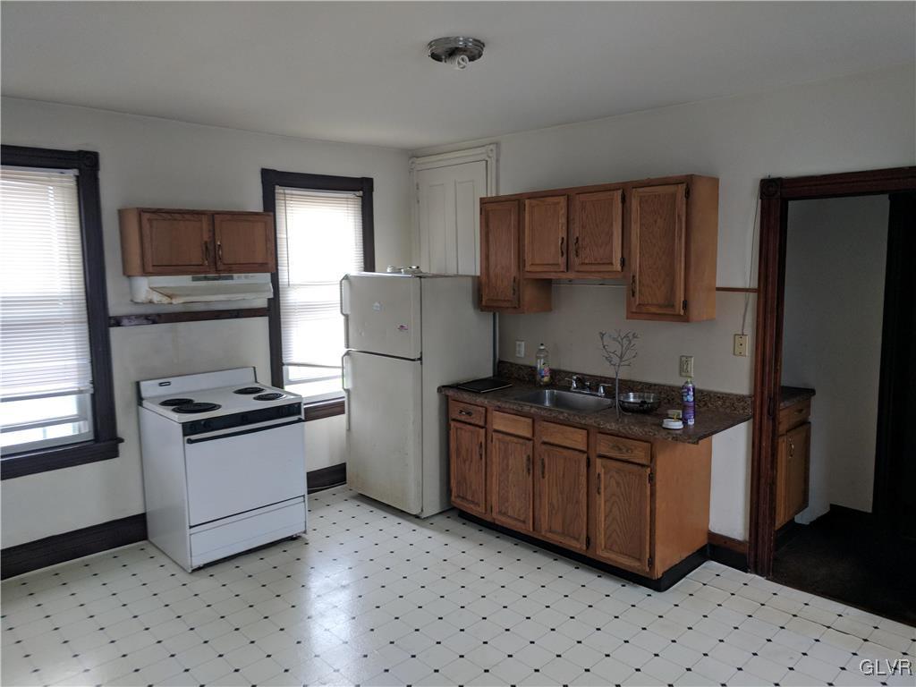 2 North 2nd Street Coplay, PA 18037 - Photo 3 of 14 a kitchen with a stove top oven and refrigerator