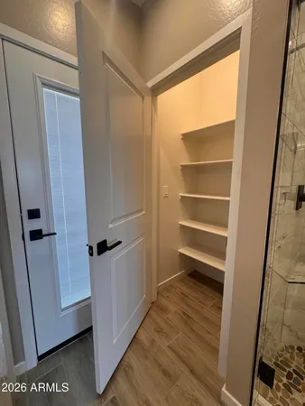 a view of hallway with wooden floor