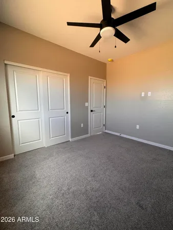 a view of a livingroom with a ceiling fan and wooden floor