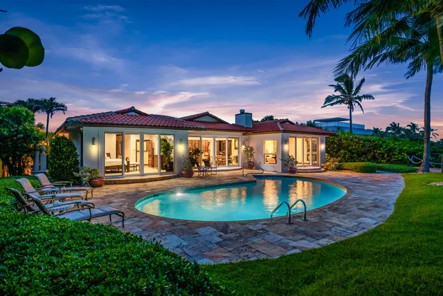 a view of a house with swimming pool and sitting area