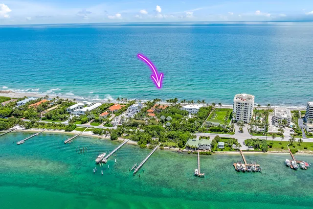 a view of a roof deck with table and chairs with wooden floor and fence