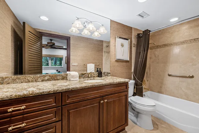 a kitchen with stainless steel appliances granite countertop a stove a refrigerator and a sink