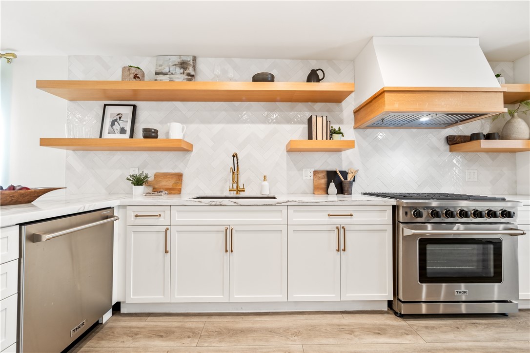 423 18th Street Huntington Beach, CA 92648 - Photo 12 of 67 a kitchen with white cabinets and appliances