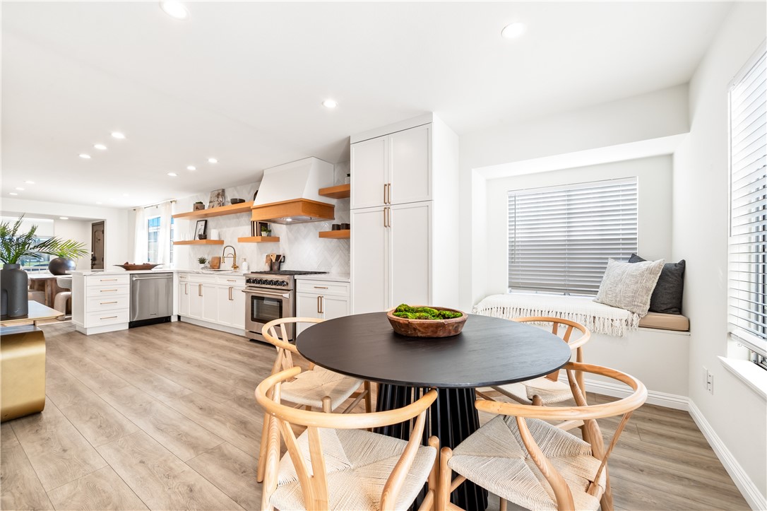 423 18th Street Huntington Beach, CA 92648 - Photo 15 of 67 a living room with stainless steel appliances a table and chairs