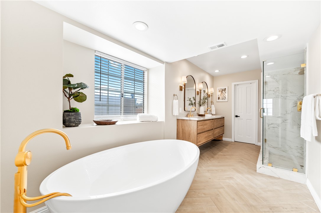 423 18th Street Huntington Beach, CA 92648 - Photo 26 of 67 a spacious bathroom with a tub sink and mirror