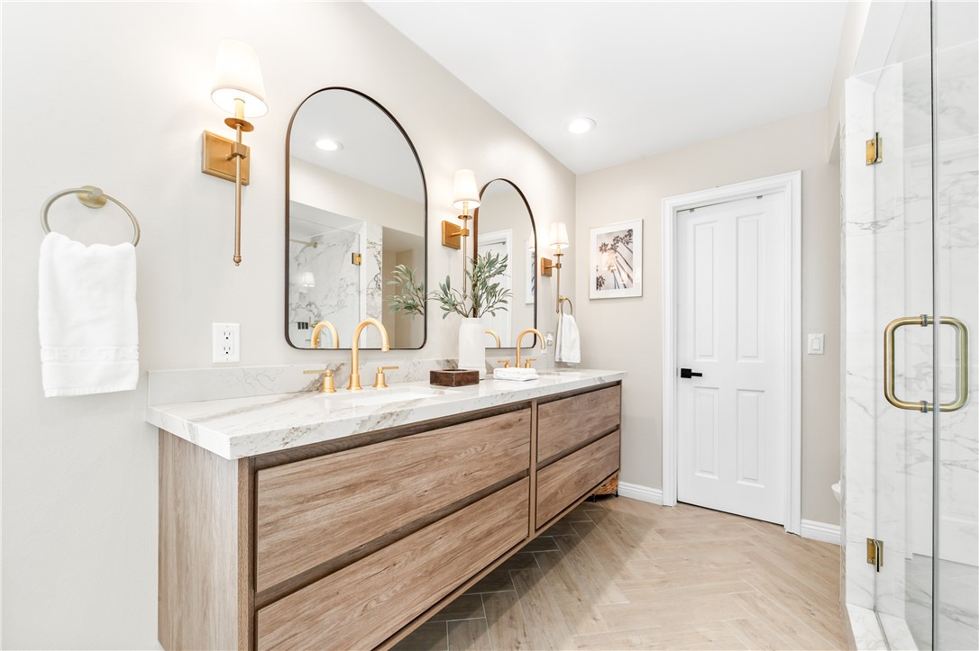 423 18th Street Huntington Beach, CA 92648 - Photo 27 of 67 a bathroom with a granite countertop sink a mirror and a shower