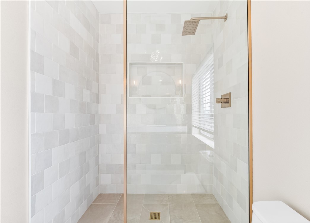 423 18th Street Huntington Beach, CA 92648 - Photo 43 of 67 a bathroom with a glass shower door