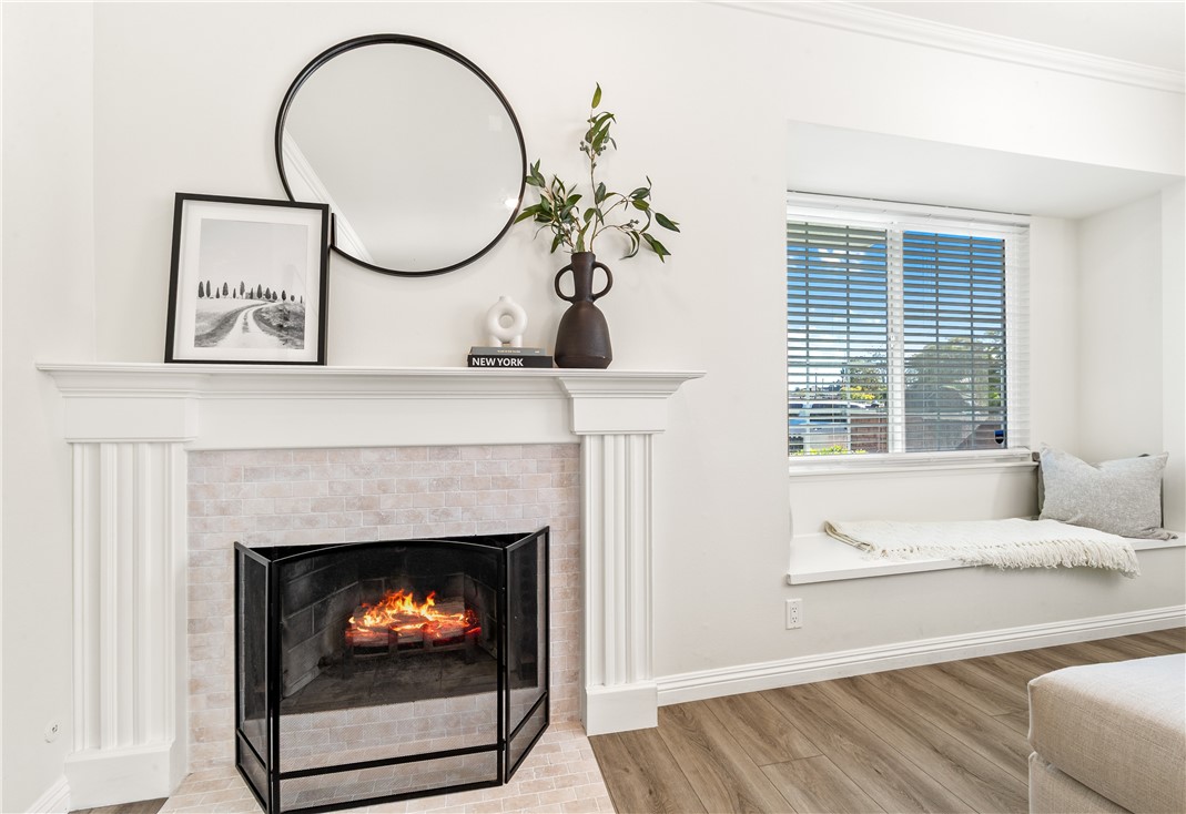 423 18th Street Huntington Beach, CA 92648 - Photo 7 of 67 a living room with a fireplace and a floor to ceiling window
