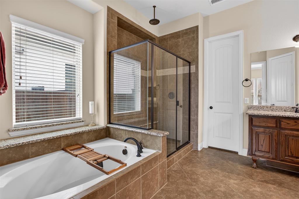 1022 Longhill Way Forney, TX 75126 - Photo 12 of 29 a bathroom with a tub sink and mirror