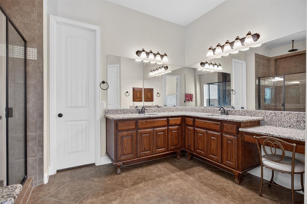 1022 Longhill Way Forney, TX 75126 - Photo 13 of 29 a spacious bathroom with a granite countertop sink a mirror and a