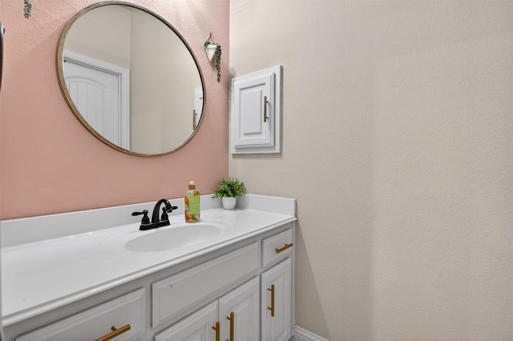 1022 Longhill Way Forney, TX 75126 - Photo 16 of 29 a bathroom with a sink and a mirror