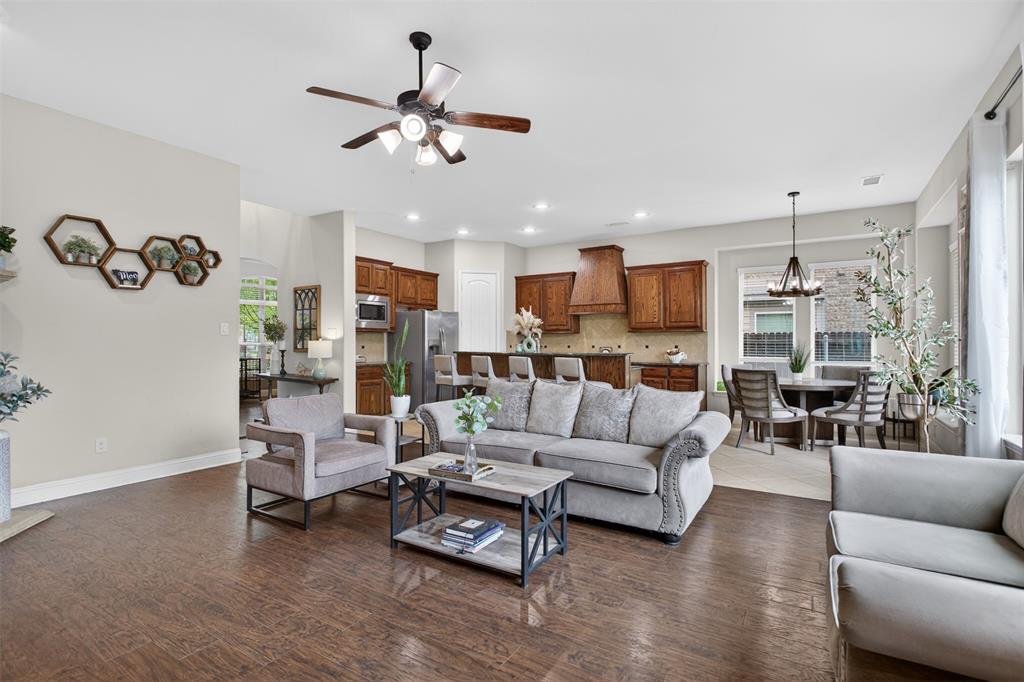 1022 Longhill Way Forney, TX 75126 - Photo 6 of 29 a living room with furniture kitchen view and a chandelier