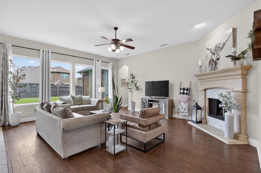 1022 Longhill Way Forney, TX 75126 - Photo 7 of 29 a living room with furniture a fireplace and a flat screen tv