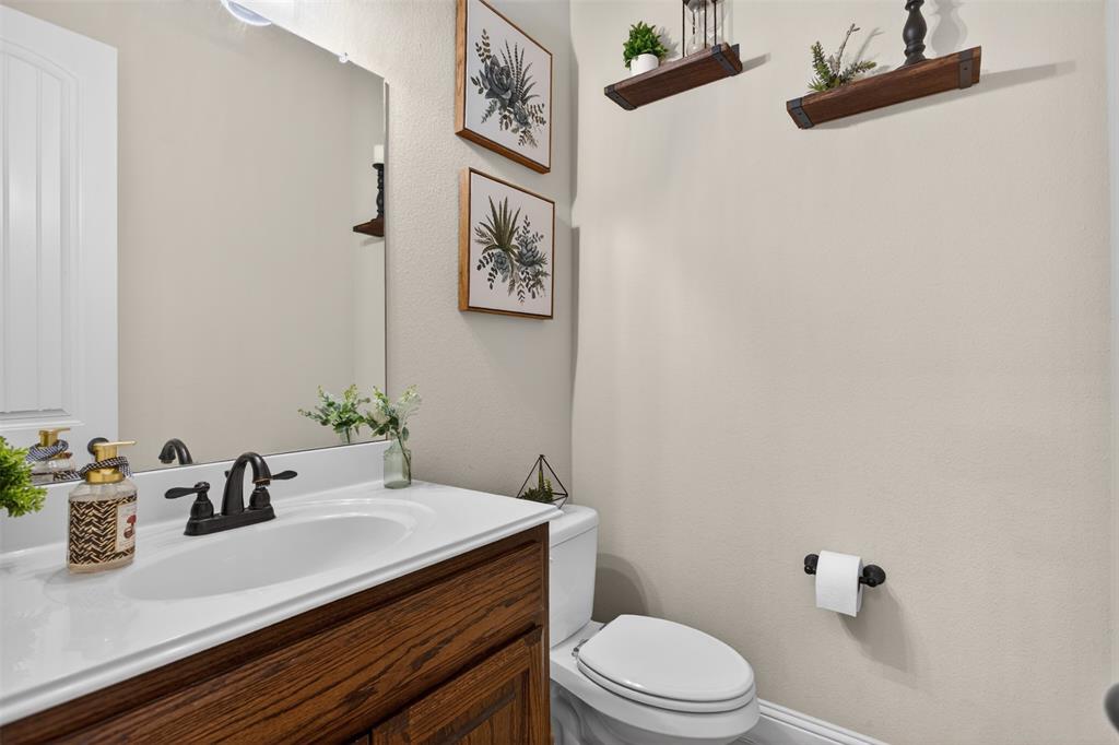 1022 Longhill Way Forney, TX 75126 - Photo 9 of 29 a bathroom with a granite countertop sink and a mirror