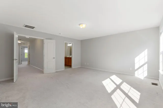 an empty room with windows and entrance