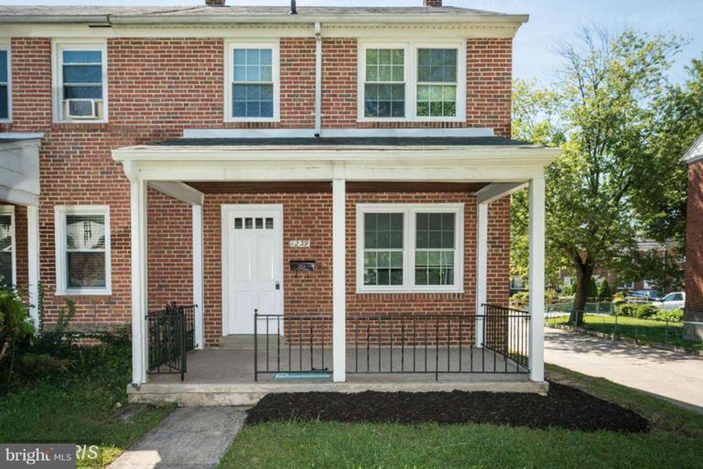 1239 Cedarcroft Road Baltimore, MD 21239 - Photo 1 of 16 front view of a house with a yard