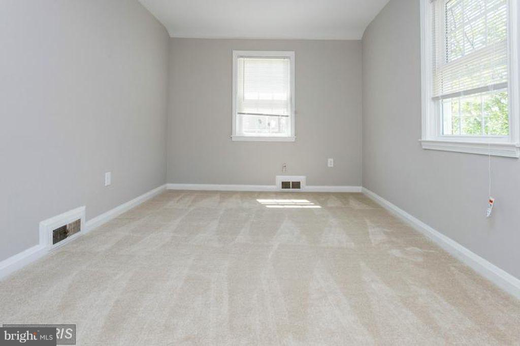 1239 Cedarcroft Road Baltimore, MD 21239 - Photo 10 of 16 an empty room with windows