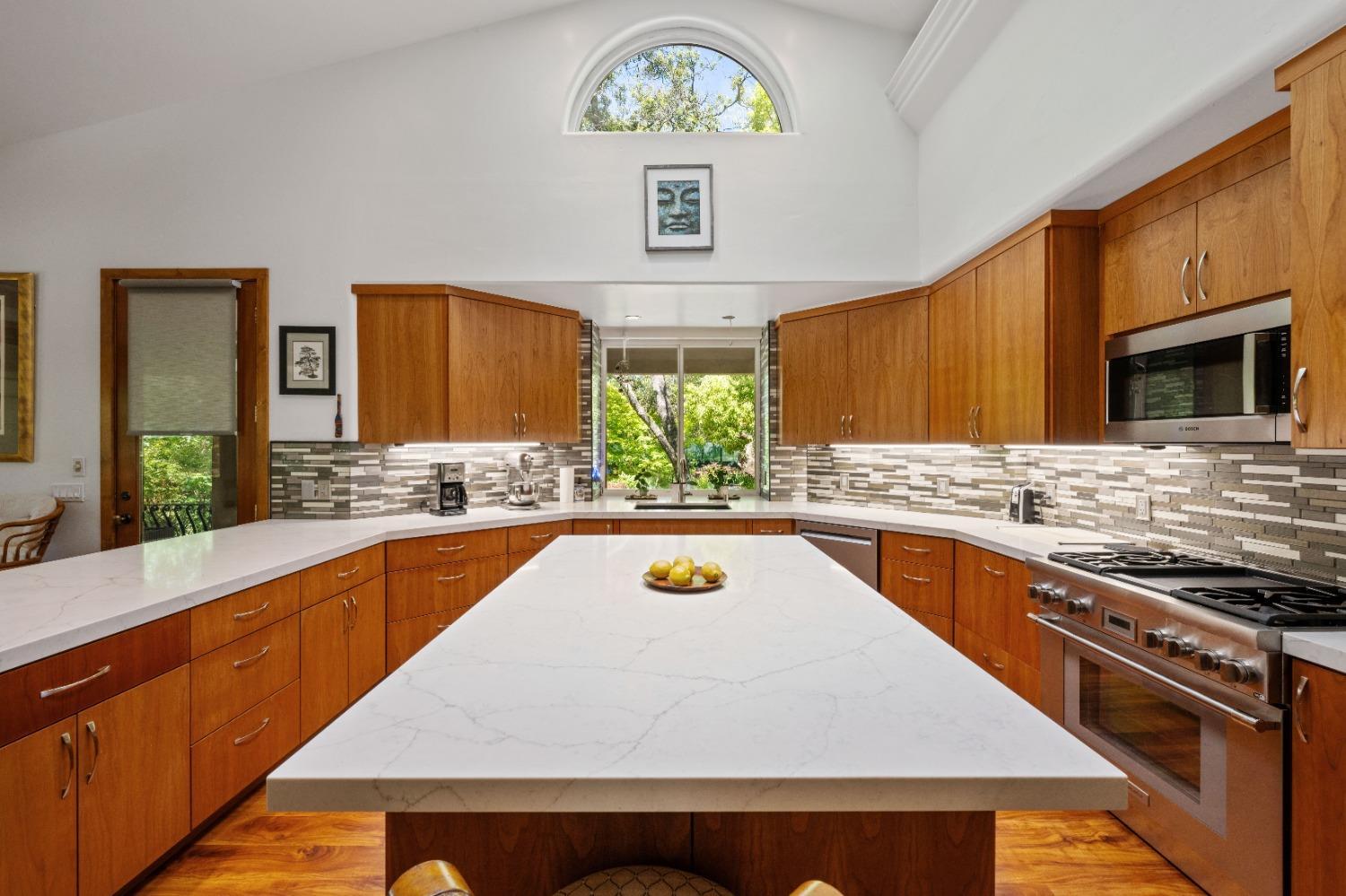 7730 Suzuki Lane Loomis, CA 95650 - Photo 11 of 62 a kitchen with stainless steel appliances a stove sink microwave and window