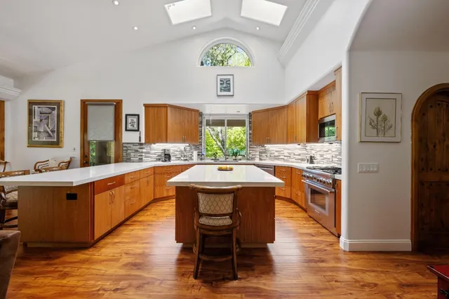 a spacious bathroom with a granite countertop sink mirror and bathtub