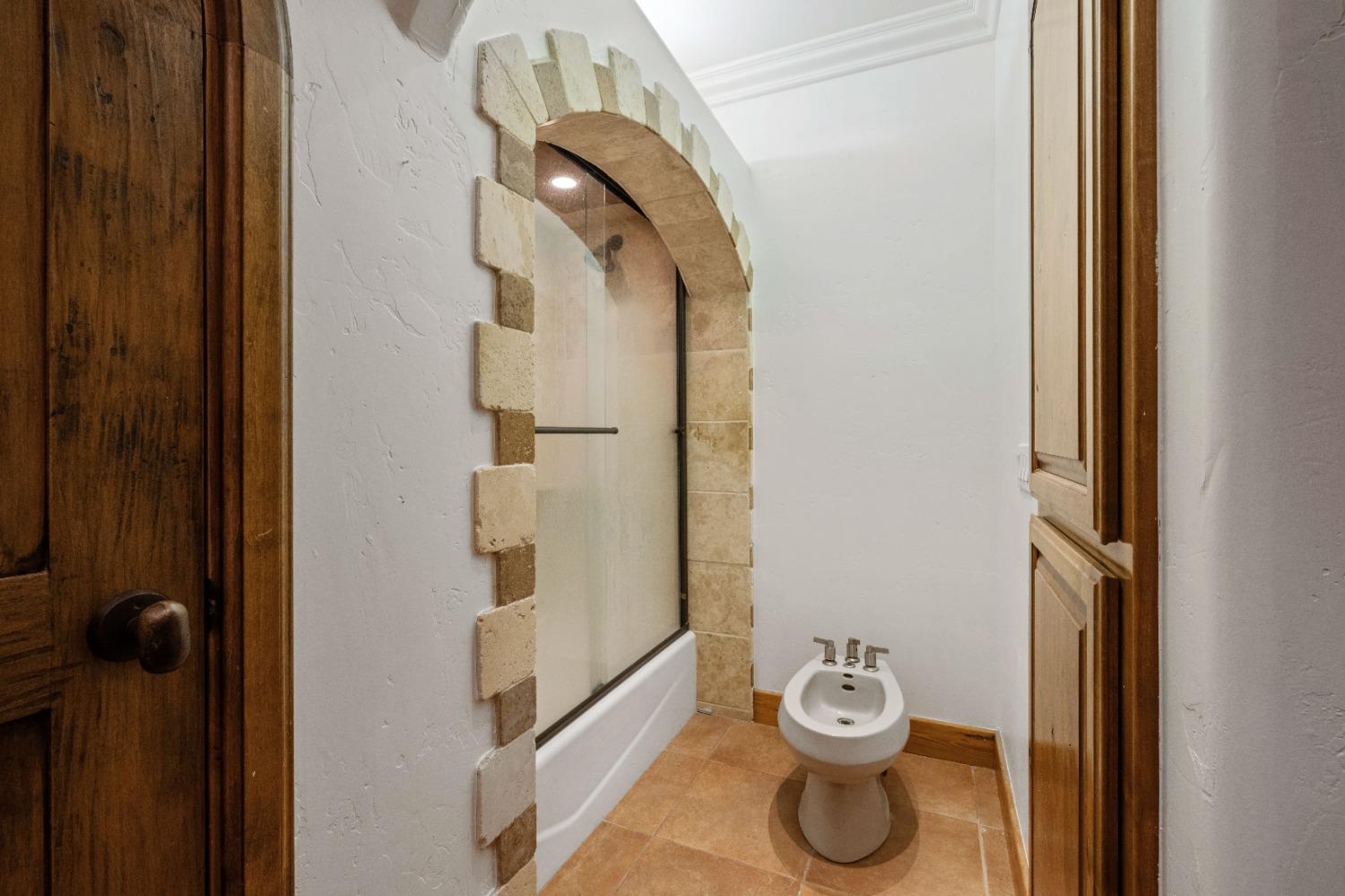 7730 Suzuki Lane Loomis, CA 95650 - Photo 32 of 62 a bathroom with a granite countertop shower a sink and toilet