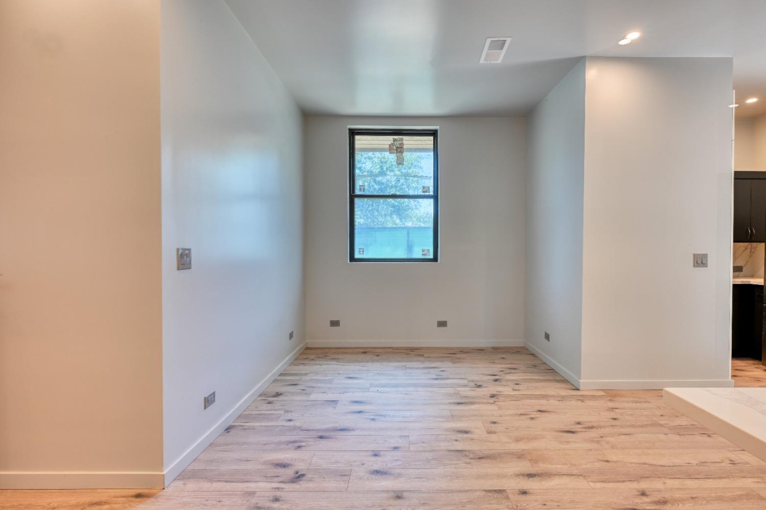 7730 Suzuki Lane Loomis, CA 95650 - Photo 40 of 62 a view of an empty room with wooden floor and a window