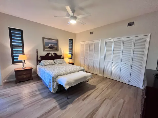 a spacious bedroom with a bed and a chandelier
