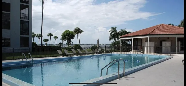 a view of house with swimming pool outdoor seating