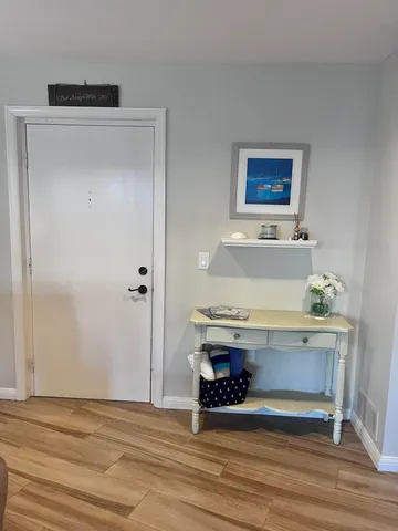 a view of workspace with wooden floor and bathroom view