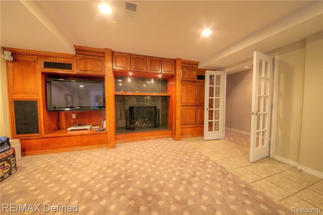 3505 Moceri Court Rochester, MI 48306 - Photo 52 of 64 Lower level Rec. room with gas fireplace and built-ins