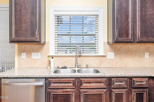 a kitchen with granite countertop a sink and a window