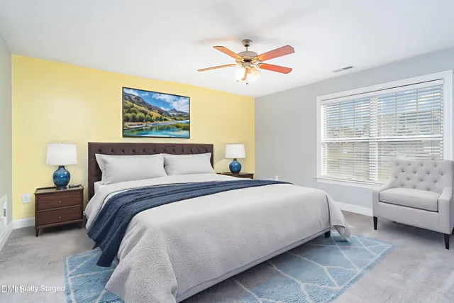 a bedroom with a bed a couch and a window