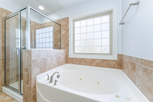 a white bath tub sitting next to a window