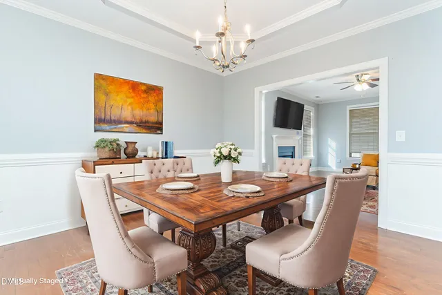 a living room with furniture fireplace and a large window