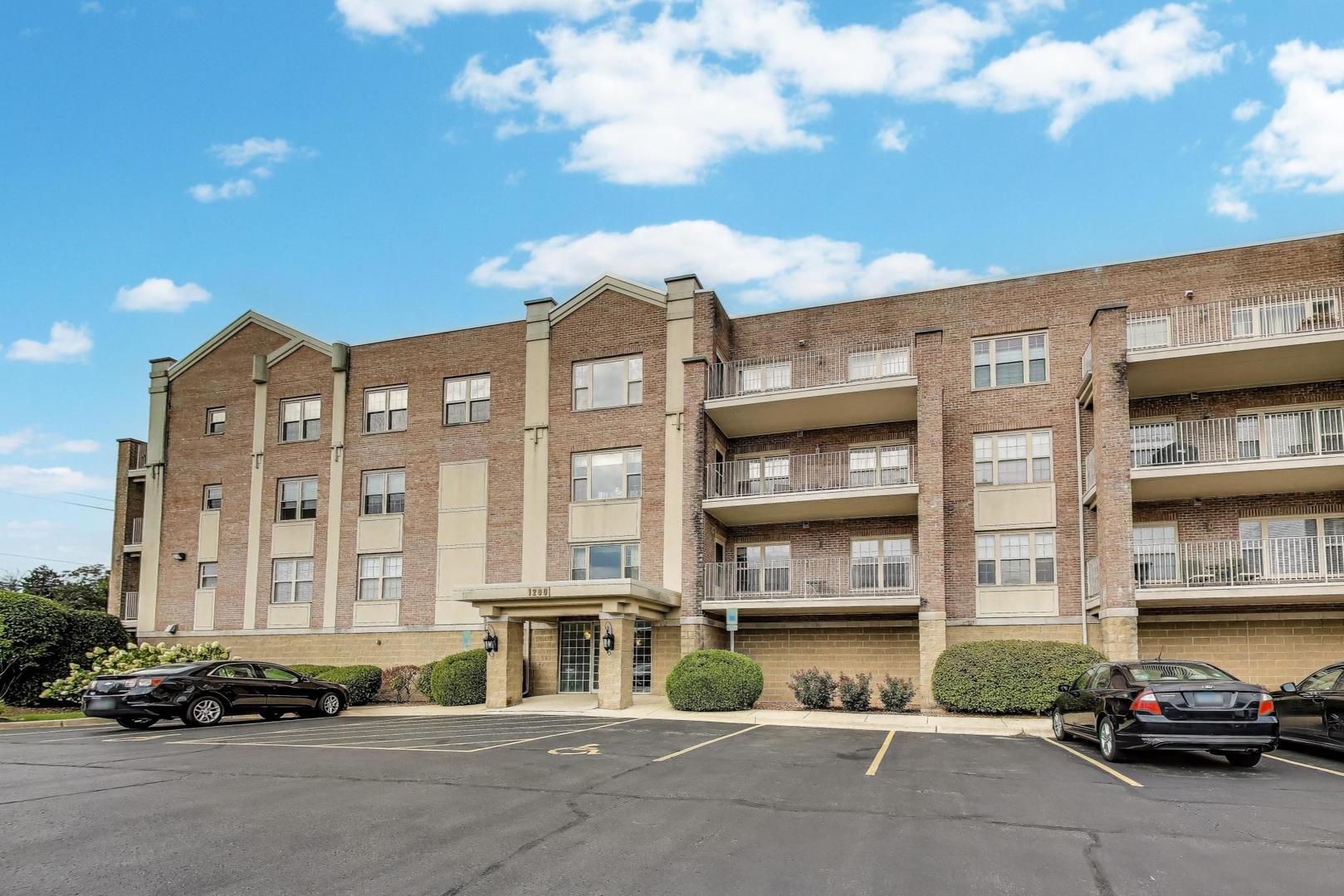a front view of a residential apartment building with a yard
