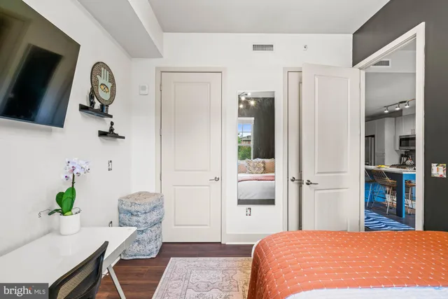 a bedroom with a large bed and a window