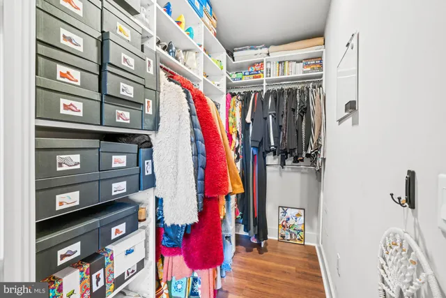 a bed sitting in a spacious bedroom next to a window