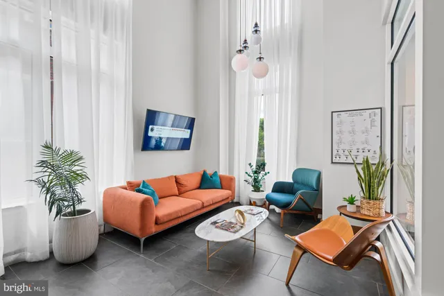 a view of a patio with couches chairs and wooden floor