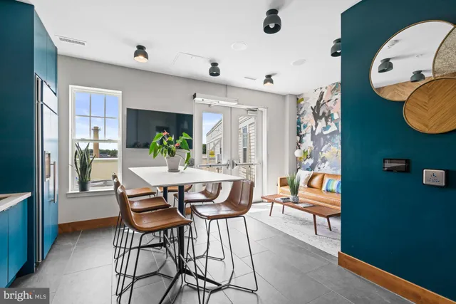 a room with furniture pool table and flat screen tv