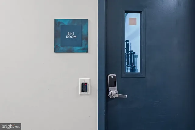 a view of tall buildings with a small yard and plants