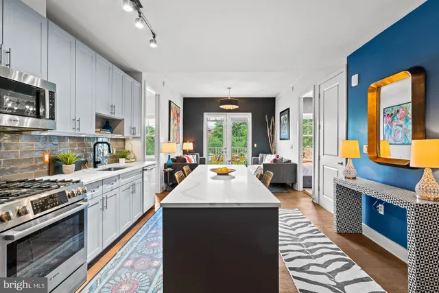 a kitchen with stainless steel appliances granite countertop a stove and a sink