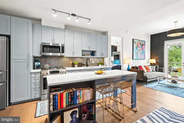 a kitchen with a stove a refrigerator and a dining table