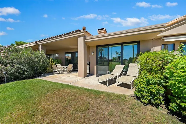 a view of a house with backyard sitting area and porch