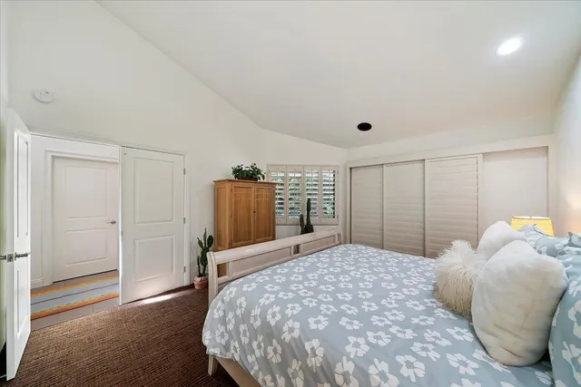 a bedroom with a large bed and a window