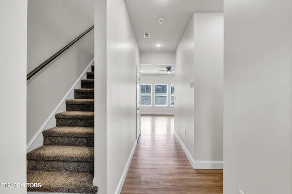 wooden floor in an empty room with stairs