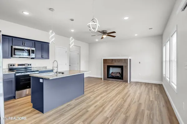 a view of kitchen with sink microwave and stove
