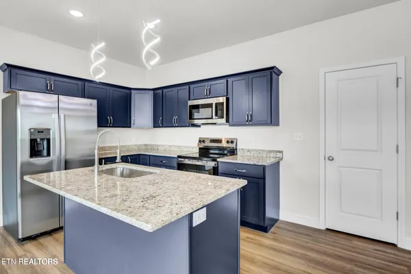 a kitchen with kitchen island granite countertop a center island appliances and cabinets