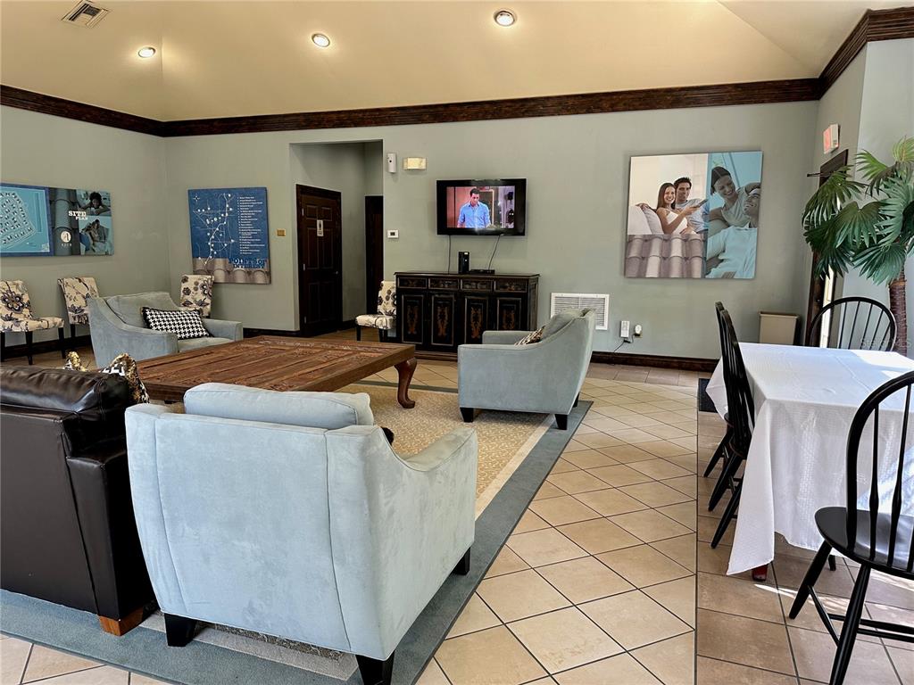 6304 Raleigh Street, Unit 202 Orlando, FL 32835 - Photo 11 of 15 a living room with furniture and a flat screen tv