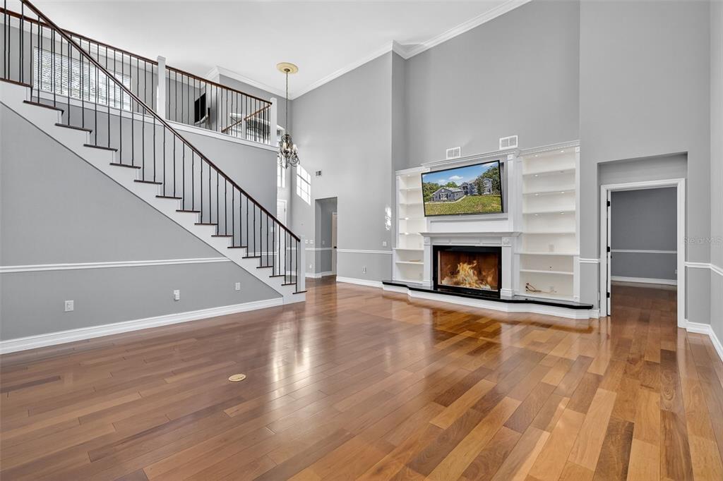 28004 Shirley Shores Road Tavares, FL 32778 - Photo 11 of 68 a view of a livingroom with wooden floor and fireplace